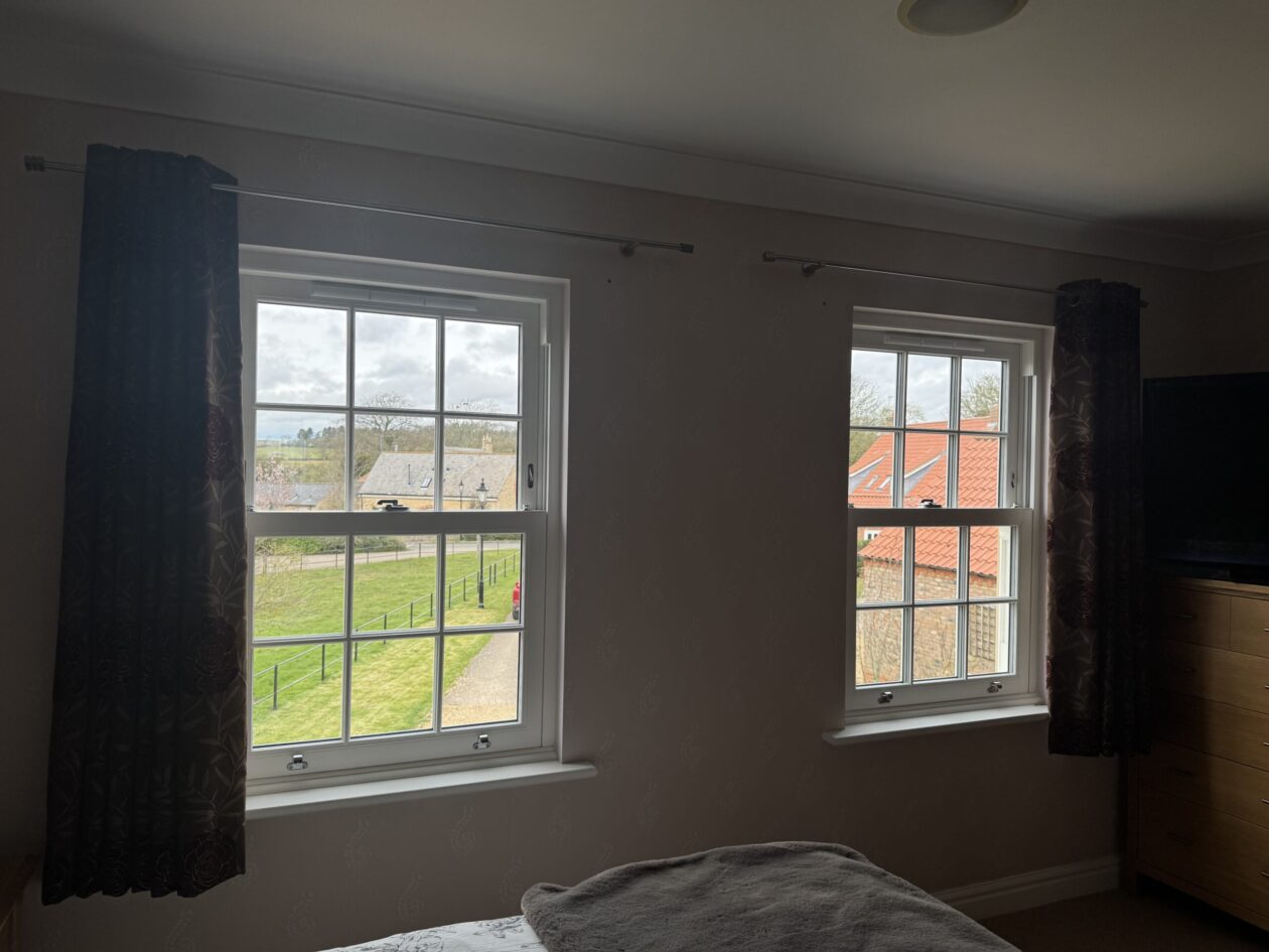 Modern uPVC sash windows opening smoothly compared to old timber windows
