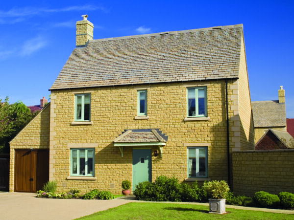 Street view of a house featuring slim-frame aluminium casement windows.